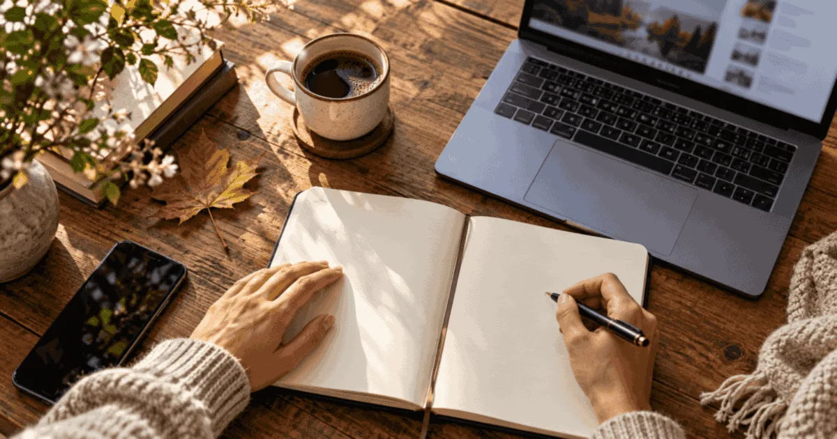 Planner and laptop for tracking November business licensing updates and deadlines.